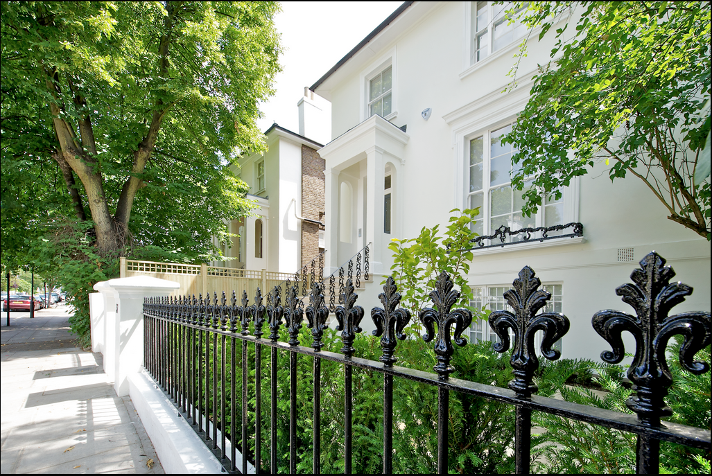 Completed exterior renovation, St John's Wood — restored ironwork, white render and mature planting